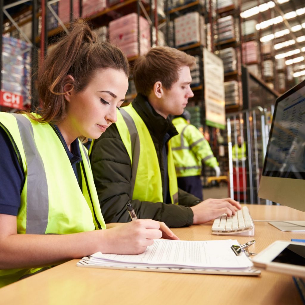 image of warehousing staff taking inventory and preparing orders